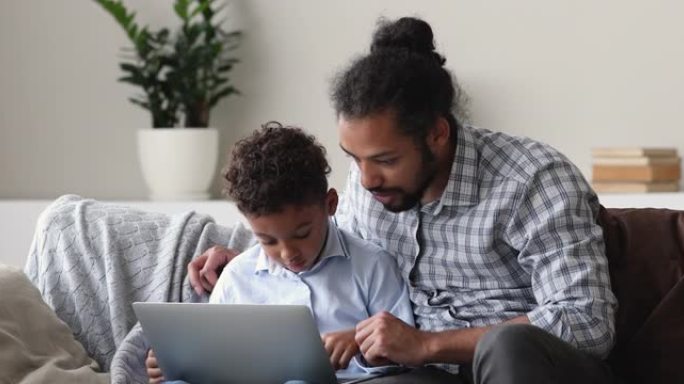 好奇的非洲男孩使用计算机应用程序学习。