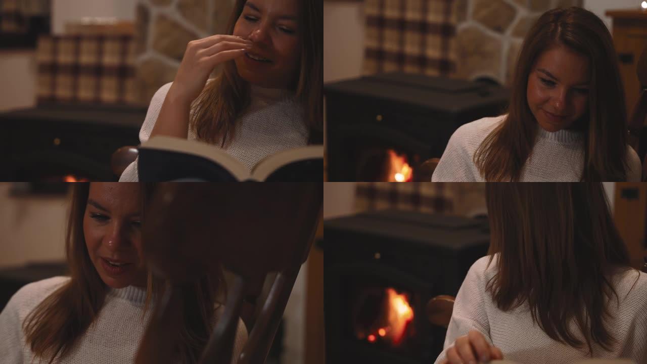 女人在家里壁炉旁的椅子上放松时看书打哈欠
