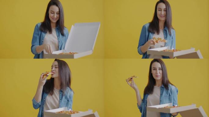 饥饿的年轻女士打开盒子的肖像看着比萨饼，在黄色背景上微笑着吃切片