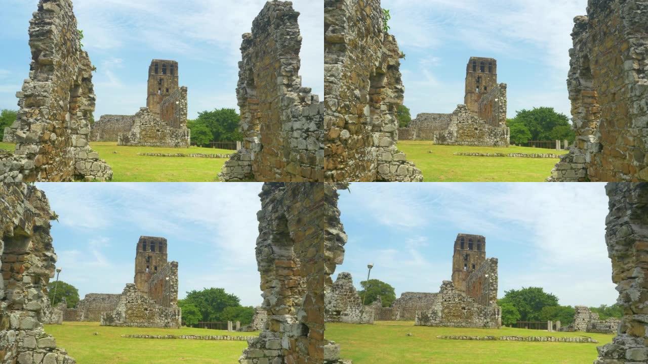 特写: 古老的大教堂塔楼位于旧巴拿马腐烂的建筑物上方。