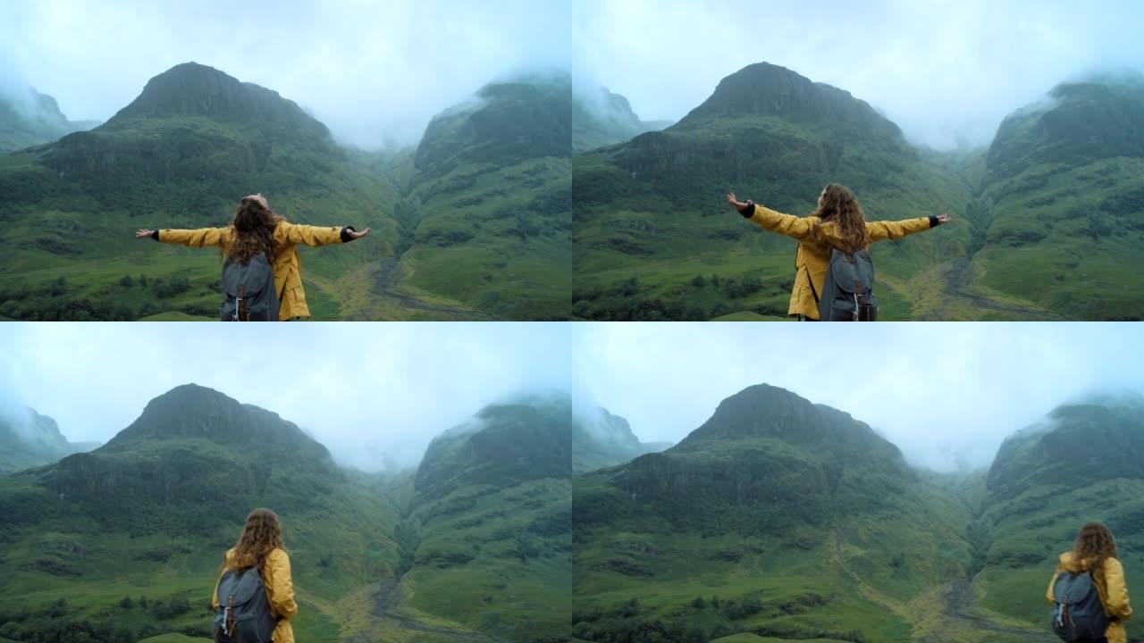 4k视频片段，一个无法识别的女人独自徒步穿越山脉