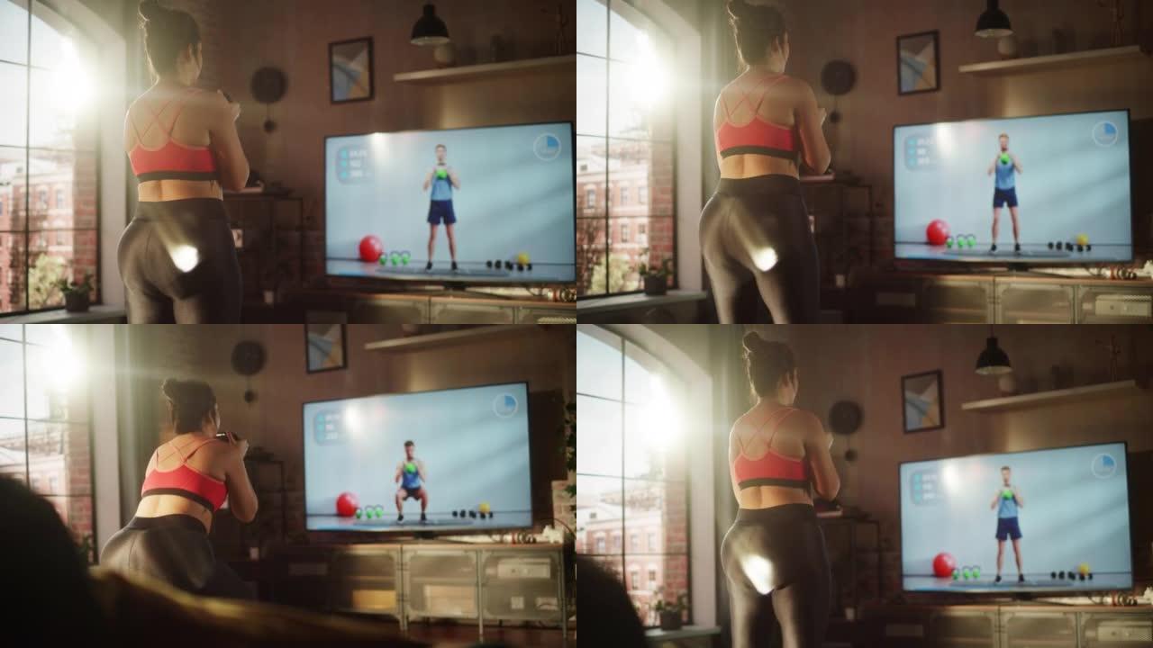 华丽的大码身体积极适合女孩训练使用壶铃，通过电视在线视频应用程序与私人教练在家里锻炼。虚拟健身房的健