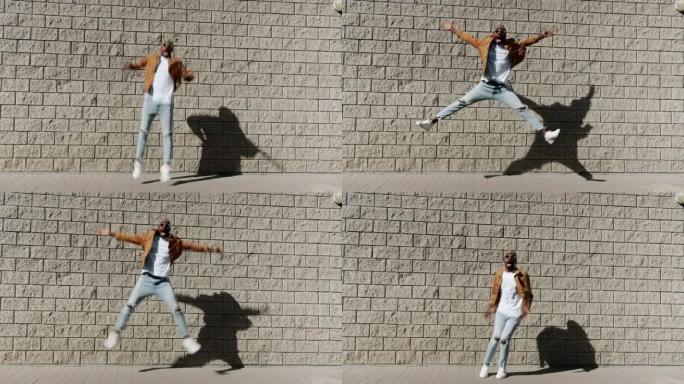 快乐的非洲裔美国人男子在砖墙背景下跳到户外的无尽循环