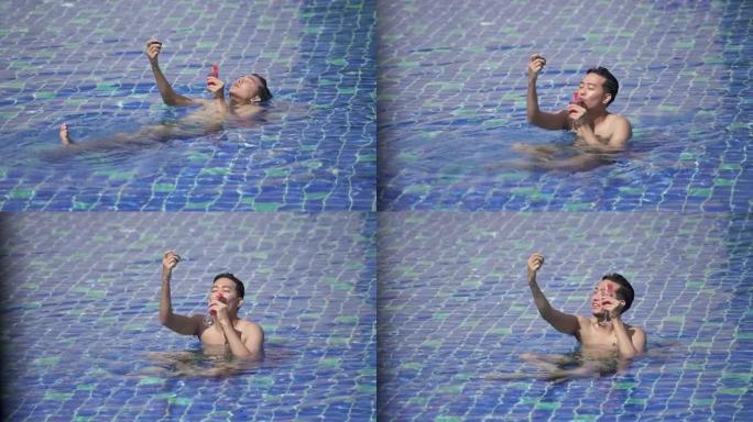 亚洲年轻人在游泳池放松时自拍