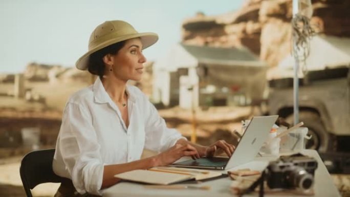 考古挖掘地点: 伟大的女性考古学家进行研究，使用笔记本电脑，分析化石遗迹，古代文明文化文物。历史学家