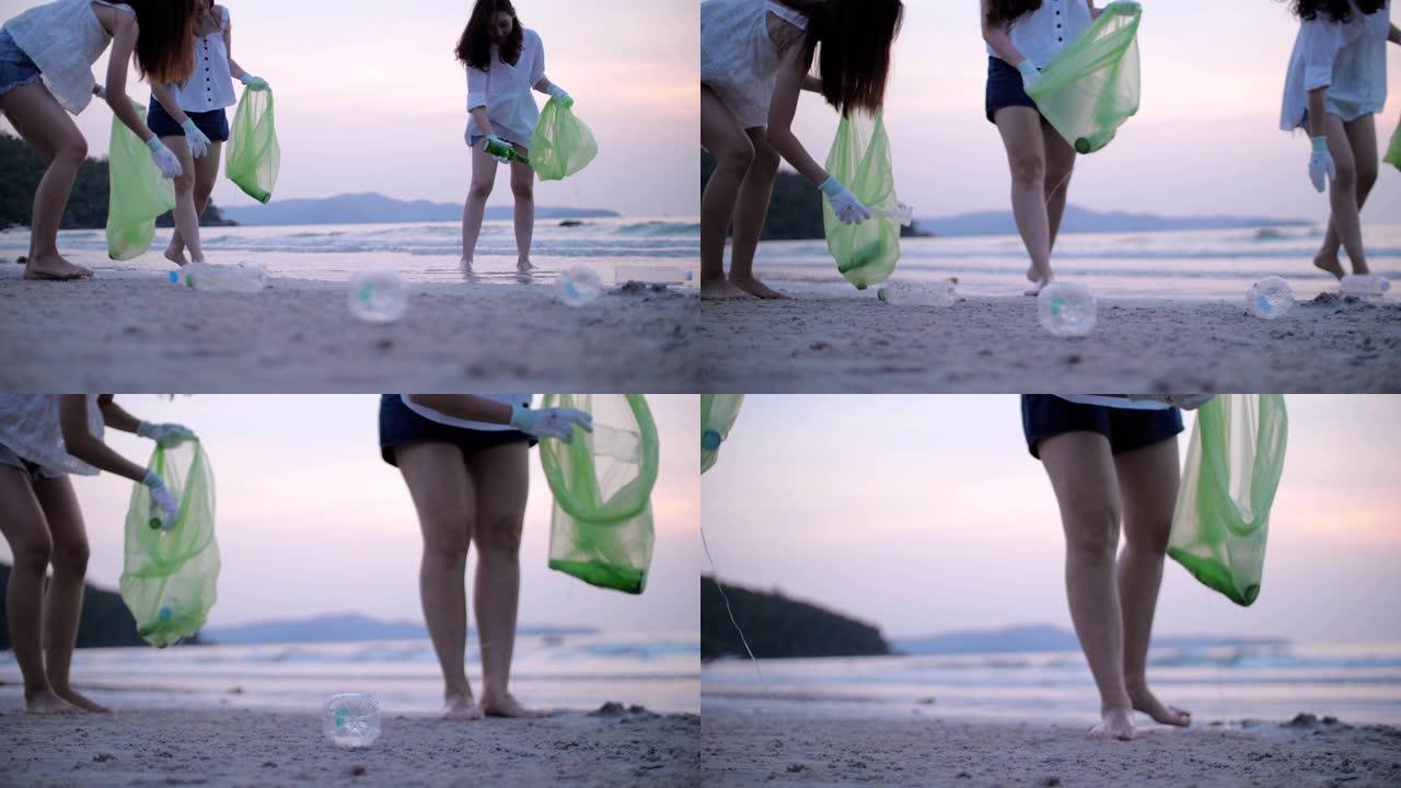 一群年轻女子在海滩上捡塑料瓶