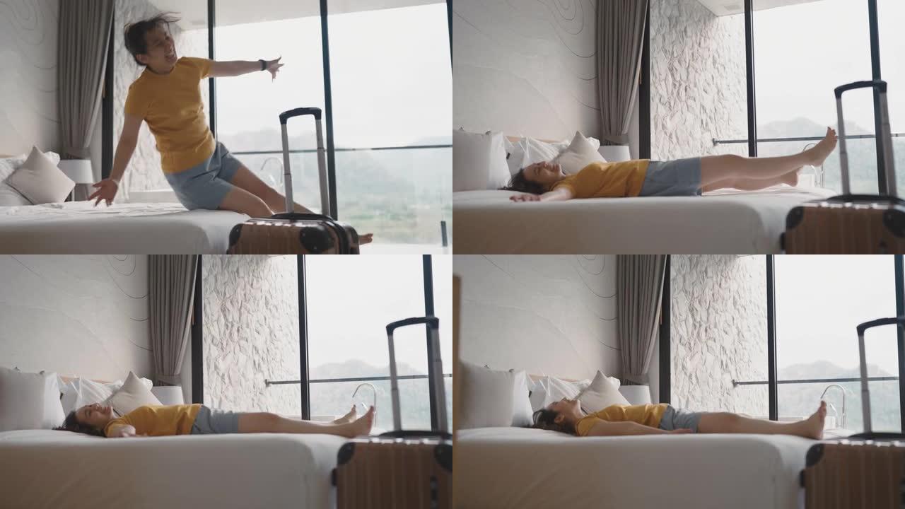 亚洲妇女在酒店房间的床上摔倒
