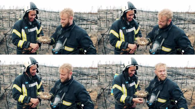 火灾发生后，两名消防员高兴地看着鸟巢
