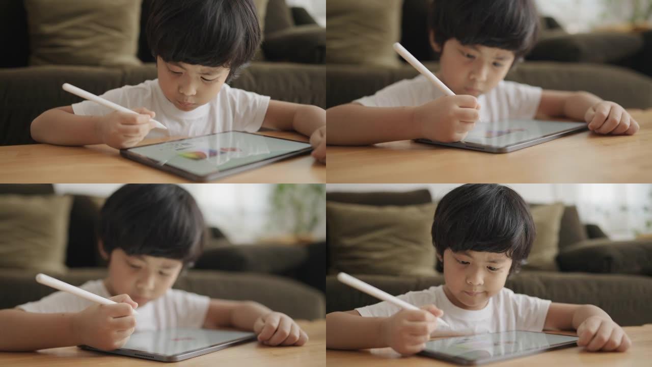 亚洲男孩数字艺术家在图形平板电脑上绘画。