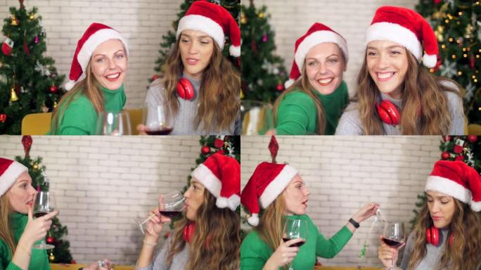 圣诞节活动中快乐的朋友喝红酒的近景