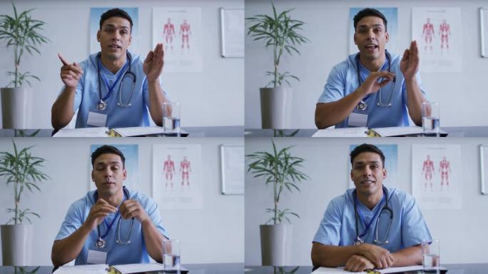 混合种族男医生在视频通话咨询期间在办公桌上说话和打手势