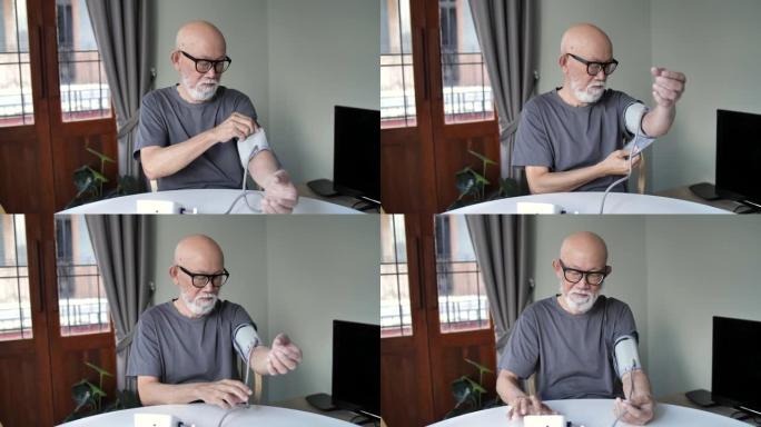 亚洲高级男子在家检查血压