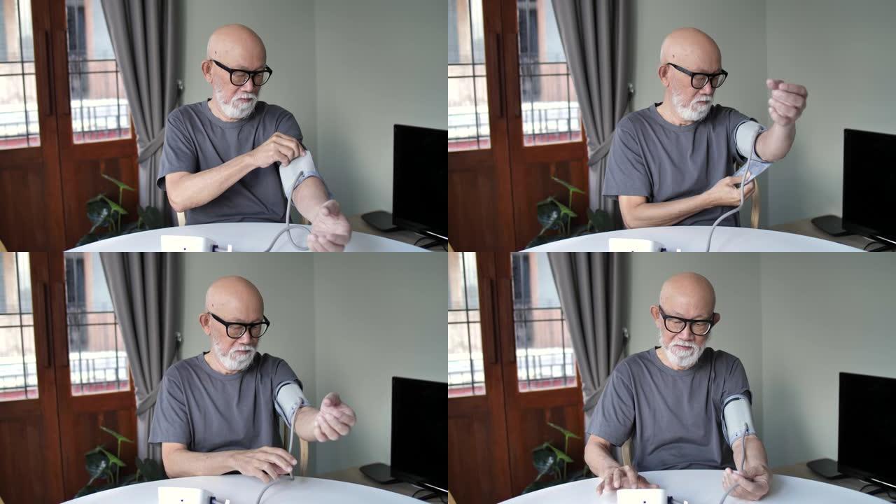 亚洲高级男子在家检查血压