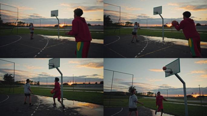 SLO MO两个十几岁的男孩在日落时打篮球