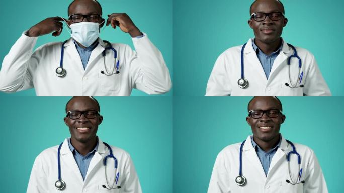 英俊的非洲裔美国医生摘下医用口罩，深呼吸，对着镜头慢动作微笑。看起来快乐和自由。特写医务人员脸部肖像