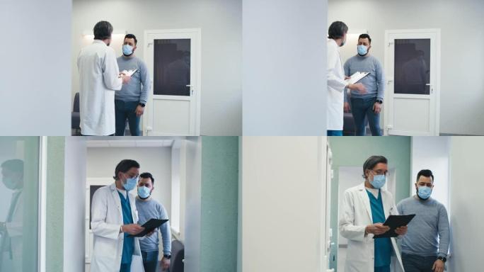 男医生在医院走廊与患者交谈