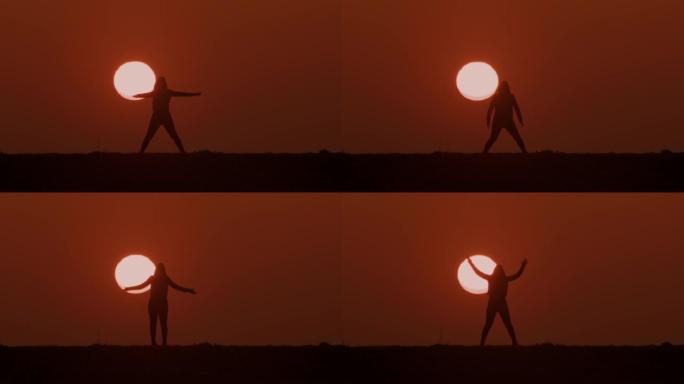 剪影中的SLO MO WS女人在日落时做热身运动