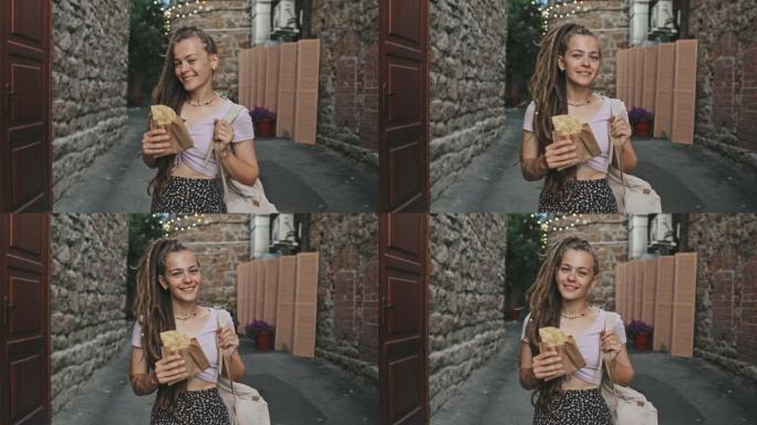 户外外卖玉米卷年轻女子肖像