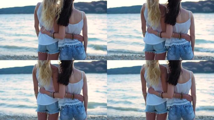 两个朋友拥抱时欣赏海景的4k视频片段