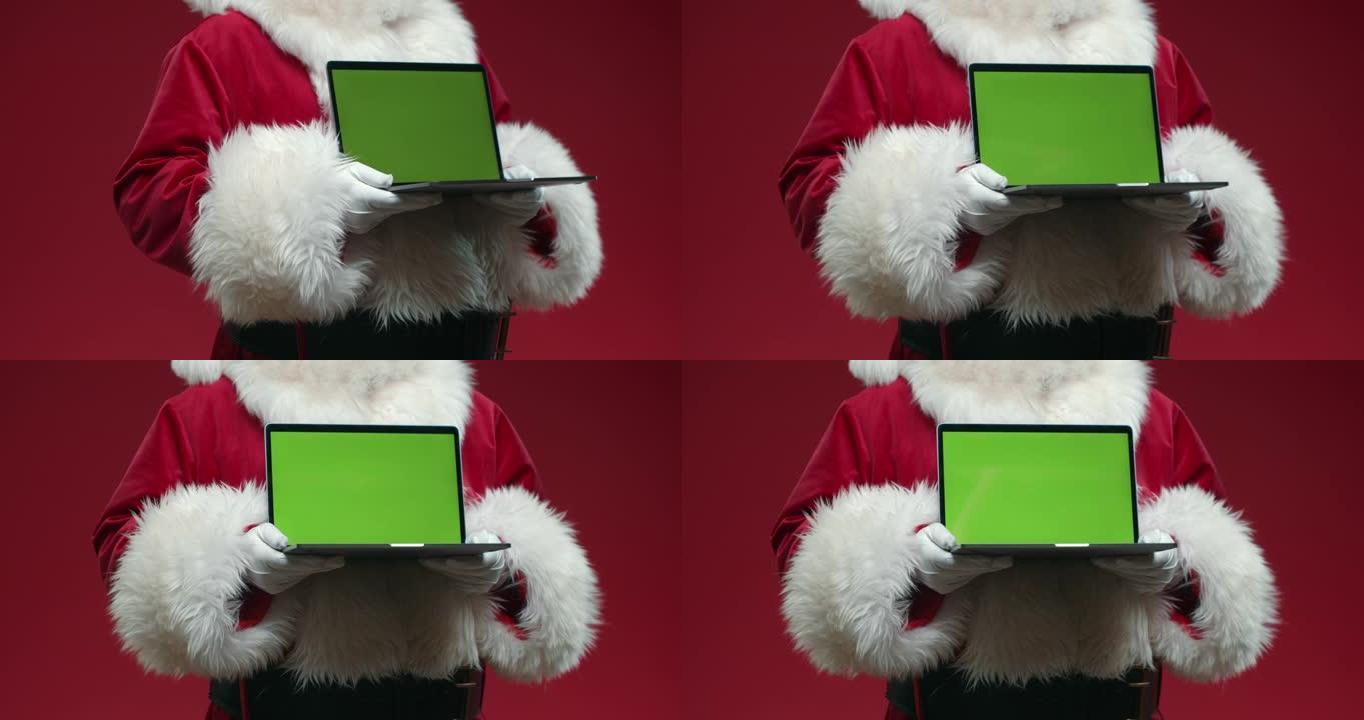 一个没有头的圣诞老人的旋转形象，手里拿着一个带色度键的笔记本电脑，在红色背景上