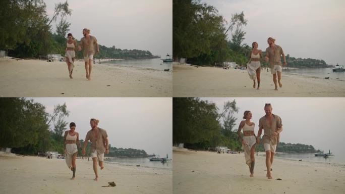 微笑的夫妇在沙滩上奔跑