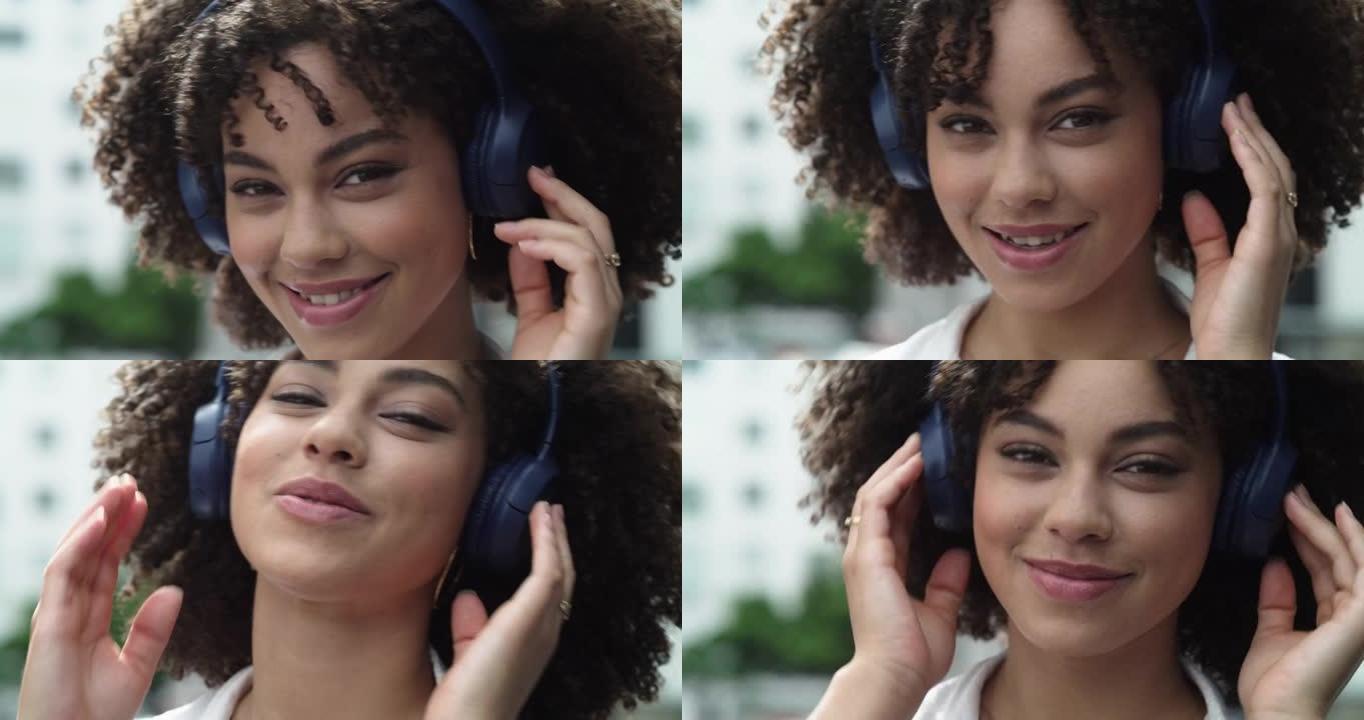 一个美丽的年轻女子站在城市外面时戴着耳机的4k视频片段