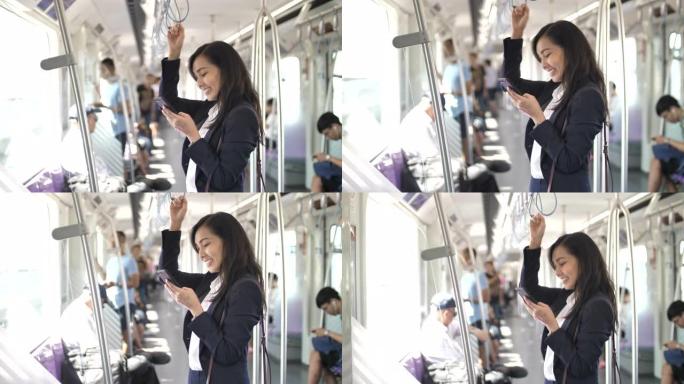 亚洲女商人在火车上使用智能手机