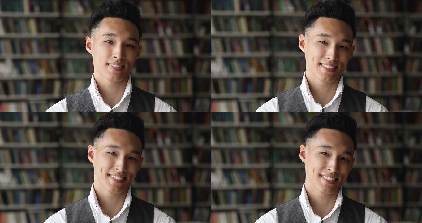 英俊的亚洲男生学生在图书馆摆姿势的头像