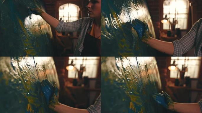 SLO MO才华横溢的女艺术家用手在画布上画画