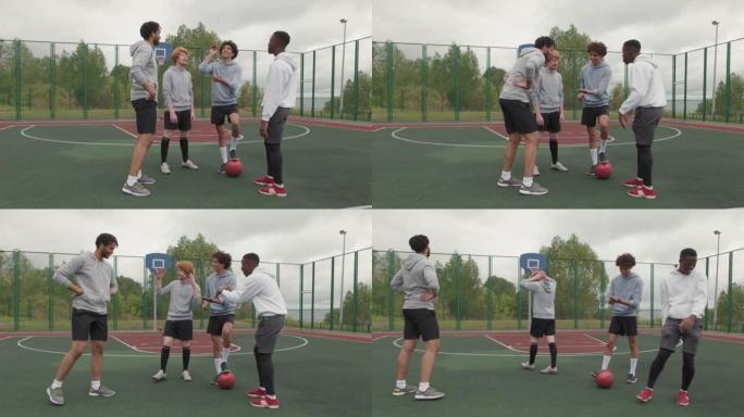 欢快的男性朋友在街球比赛前掷硬币