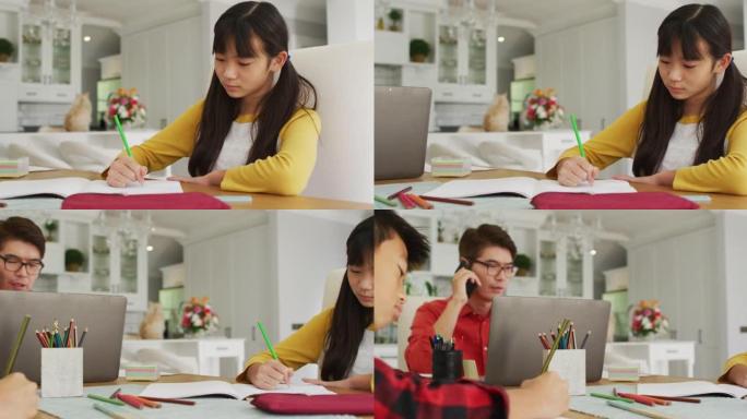 亚洲父亲使用智能手机和笔记本电脑在厨房工作，儿子和女儿在做功课