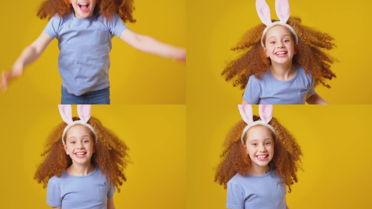 工作室拍摄的女孩戴着兔子耳朵从框架底部跳到黄色背景下-慢动作拍摄