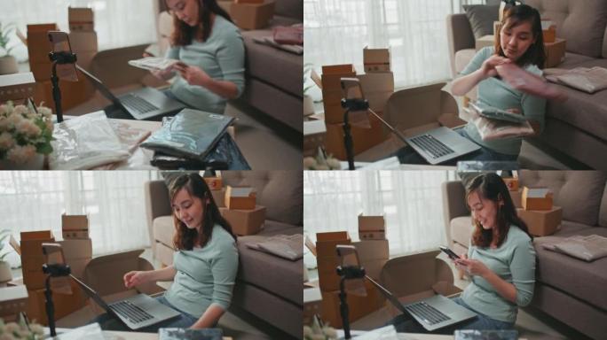 女人在网上使用笔记本电脑直播衬衫。小企业概念
