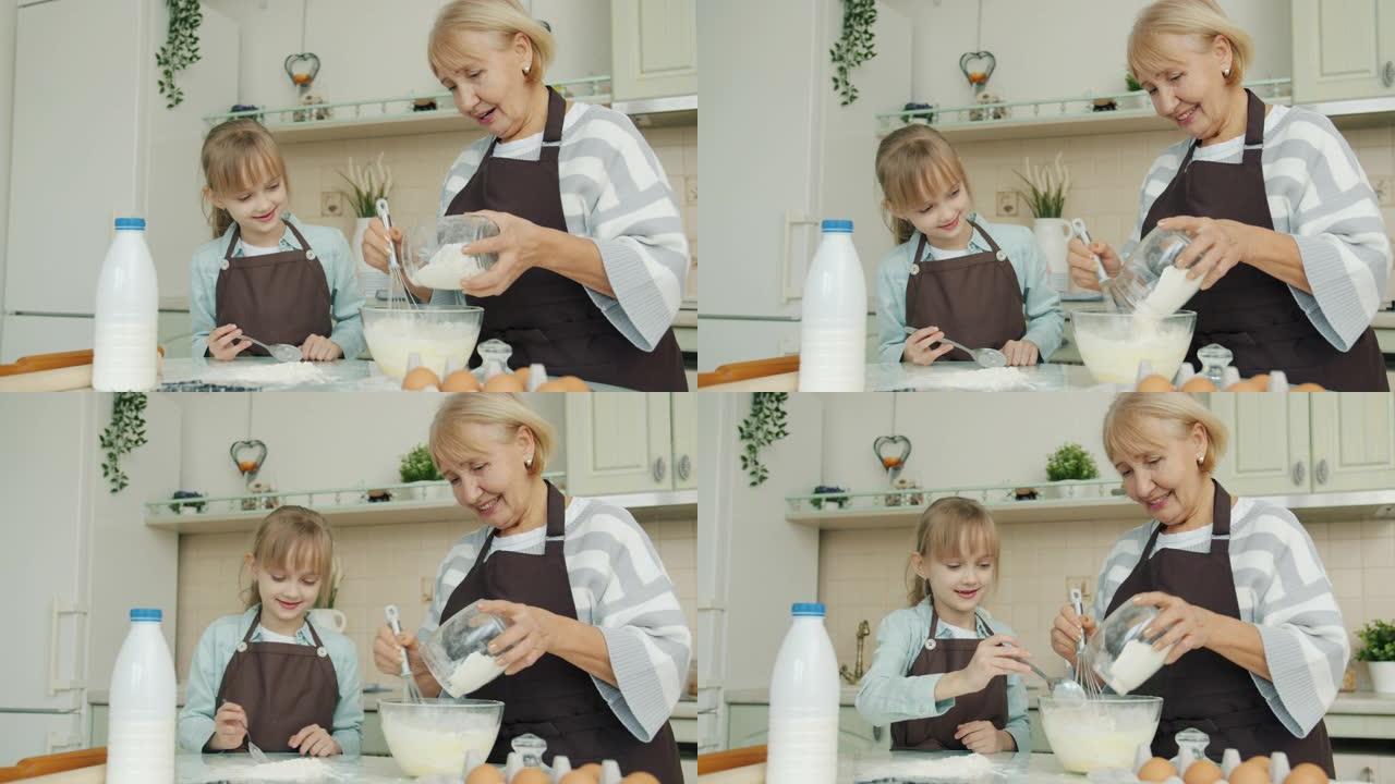 奶奶经验丰富的厨师一起在厨房里教小女孩做糕点