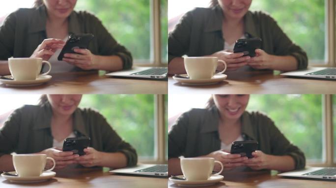咖啡馆里使用智能手机的女人