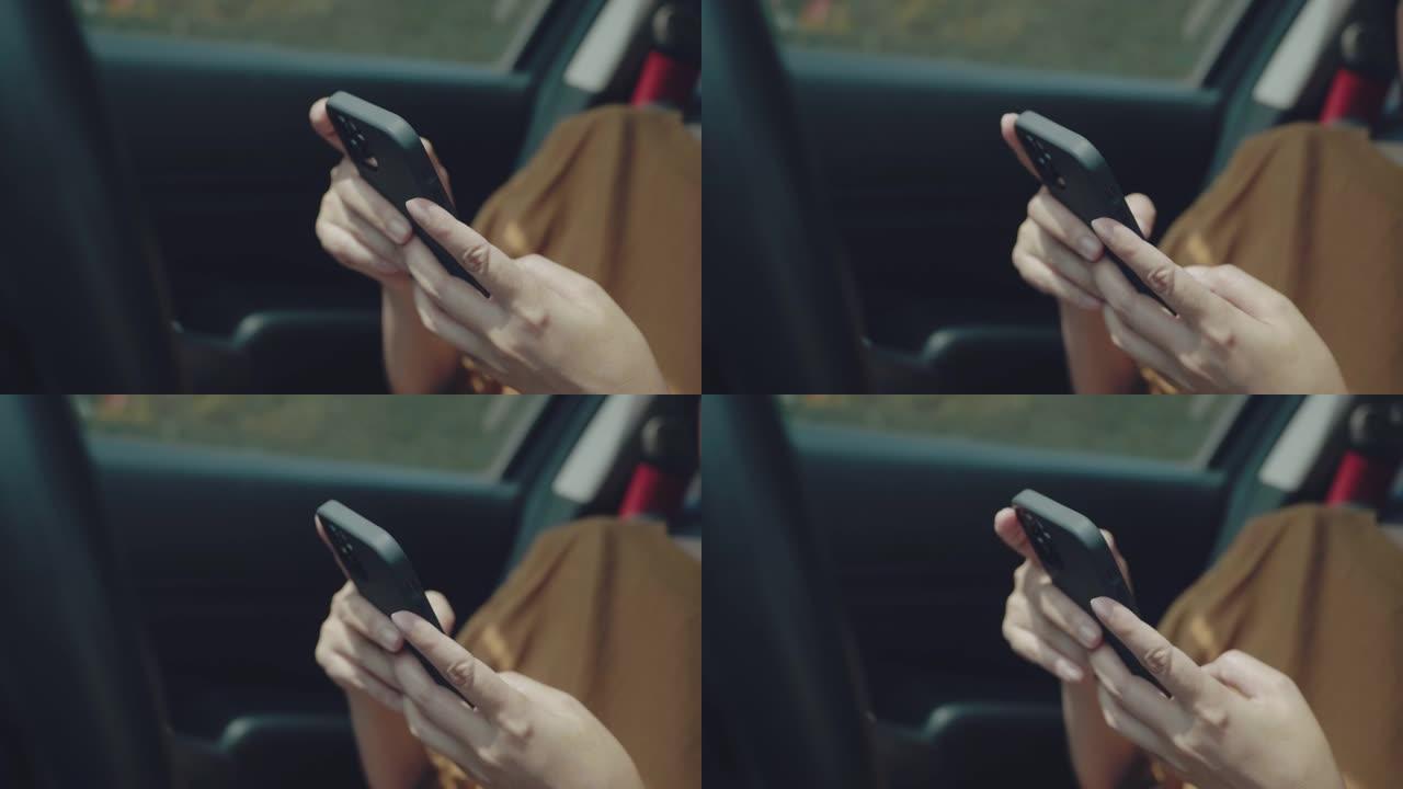 年轻女子乘坐智能手机上带有导航仪的汽车