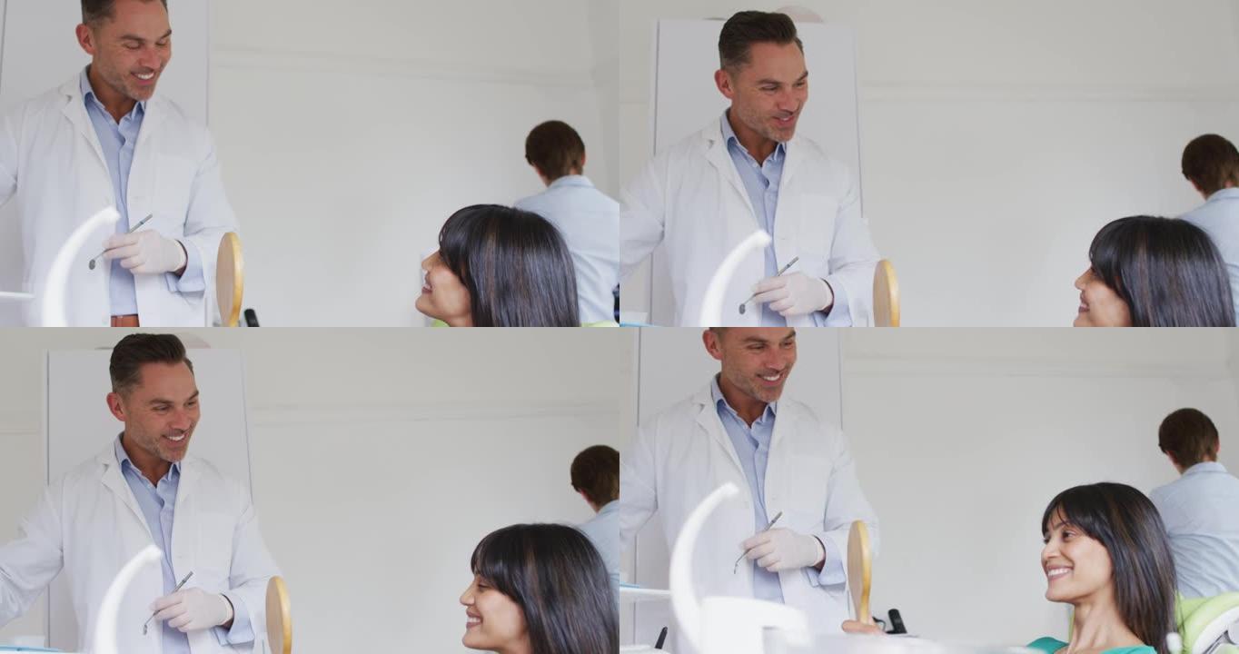 微笑的白人男性牙医在现代牙科诊所与女性患者交谈