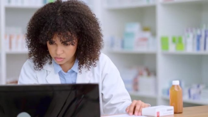 年轻而忙碌的药剂师在药房药房盘点和配药时检查她的计算机。女性卫生专业人员或化学家填写处方药文件