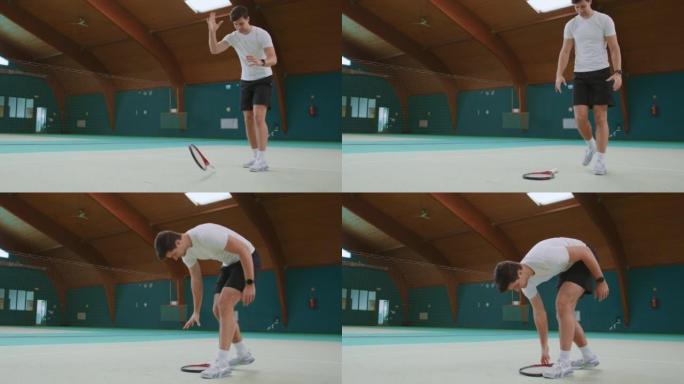 失望的年轻网球运动员将球拍扔在地上