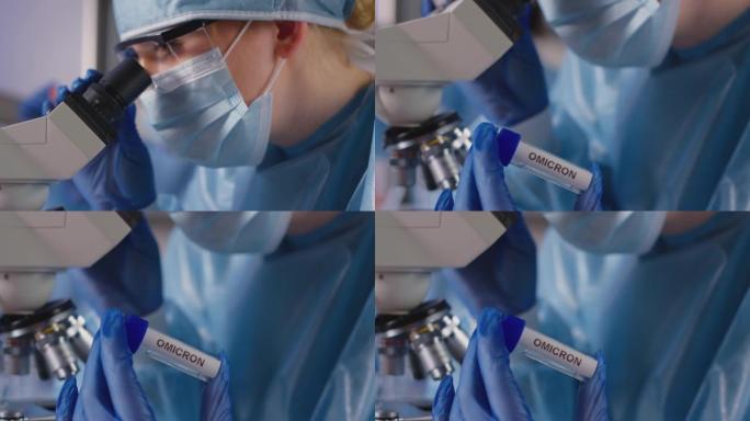 女实验室工作人员穿着个人防护用品，拿着标有Omicron标签的试管，分析样品