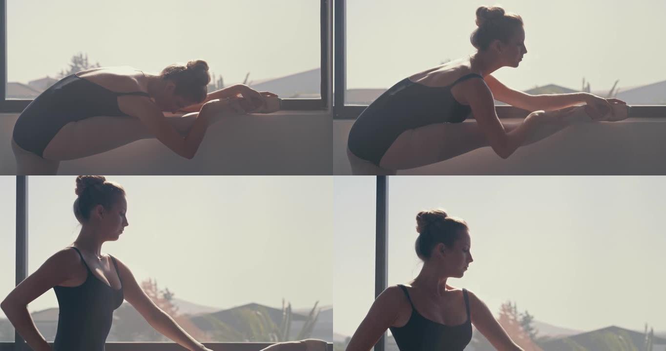 4k视频片段，一名年轻女子在芭蕾舞工作室中伸展