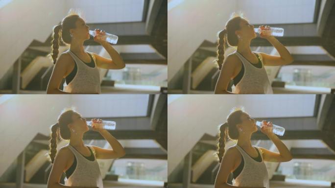 运动后的年轻女子喝水
