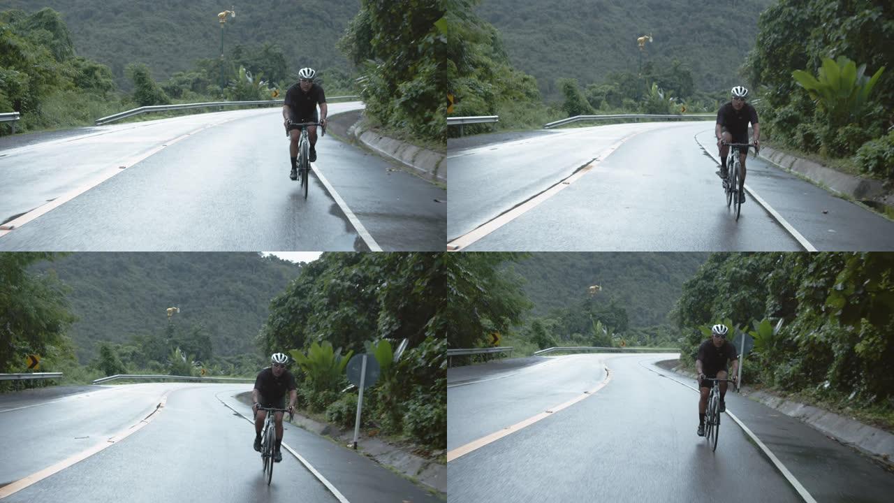 亚洲青年男子骑自行车公路旅行