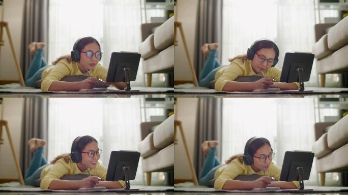 年轻的亚洲女性是家庭学校，在数字平板电脑、家庭生活、家庭工作、新工作场所进行电子学习