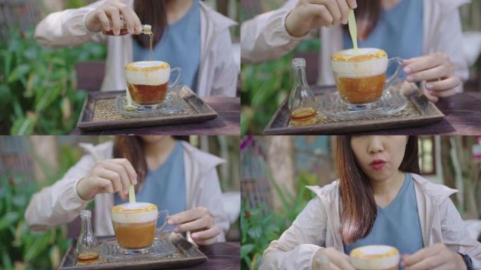 亚洲妇女在素食凉茶和饮料上倒糖浆