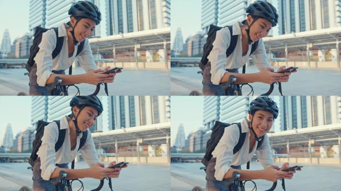 带着背包微笑的亚洲女商人在城市站在街上骑自行车去办公室上班。