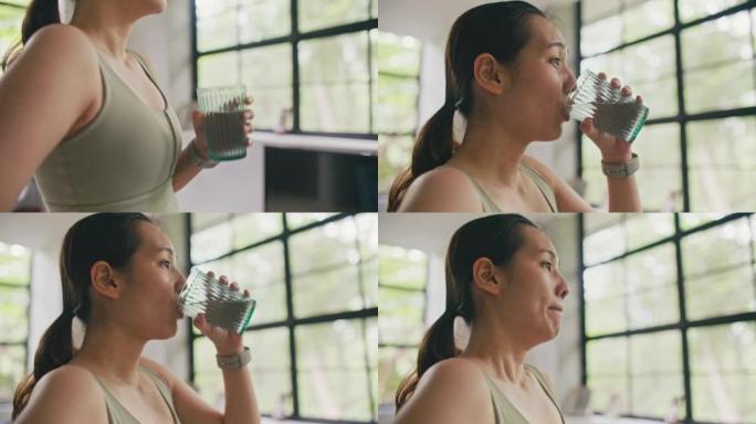 亚洲年轻女子在高强度锻炼后喝水补水