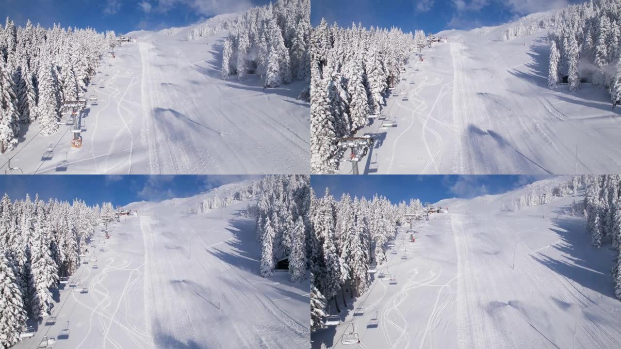 空中: 带有作业造雪机的积雪覆盖的封闭滑雪场的视图