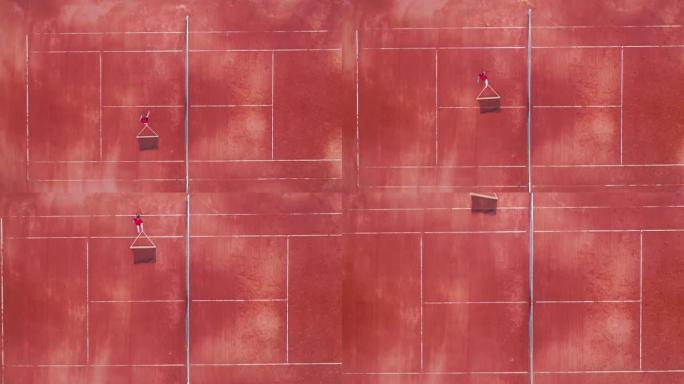 一名男子正在俯视图中通过球场重新放置网球网