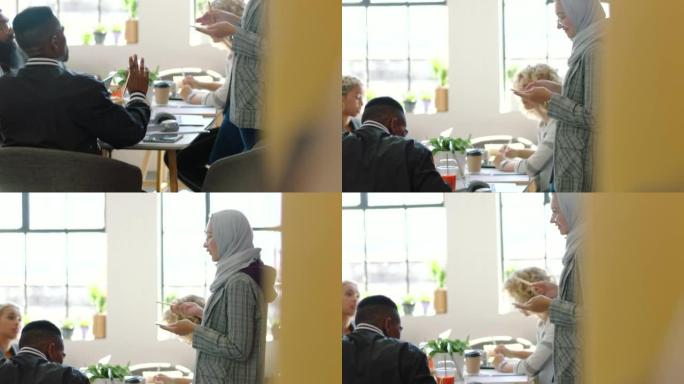 会议，想法和穆斯林妇女发言人，电话头脑风暴，手持动作。在创意办公室进行团队合作，合作和演示，以培训或